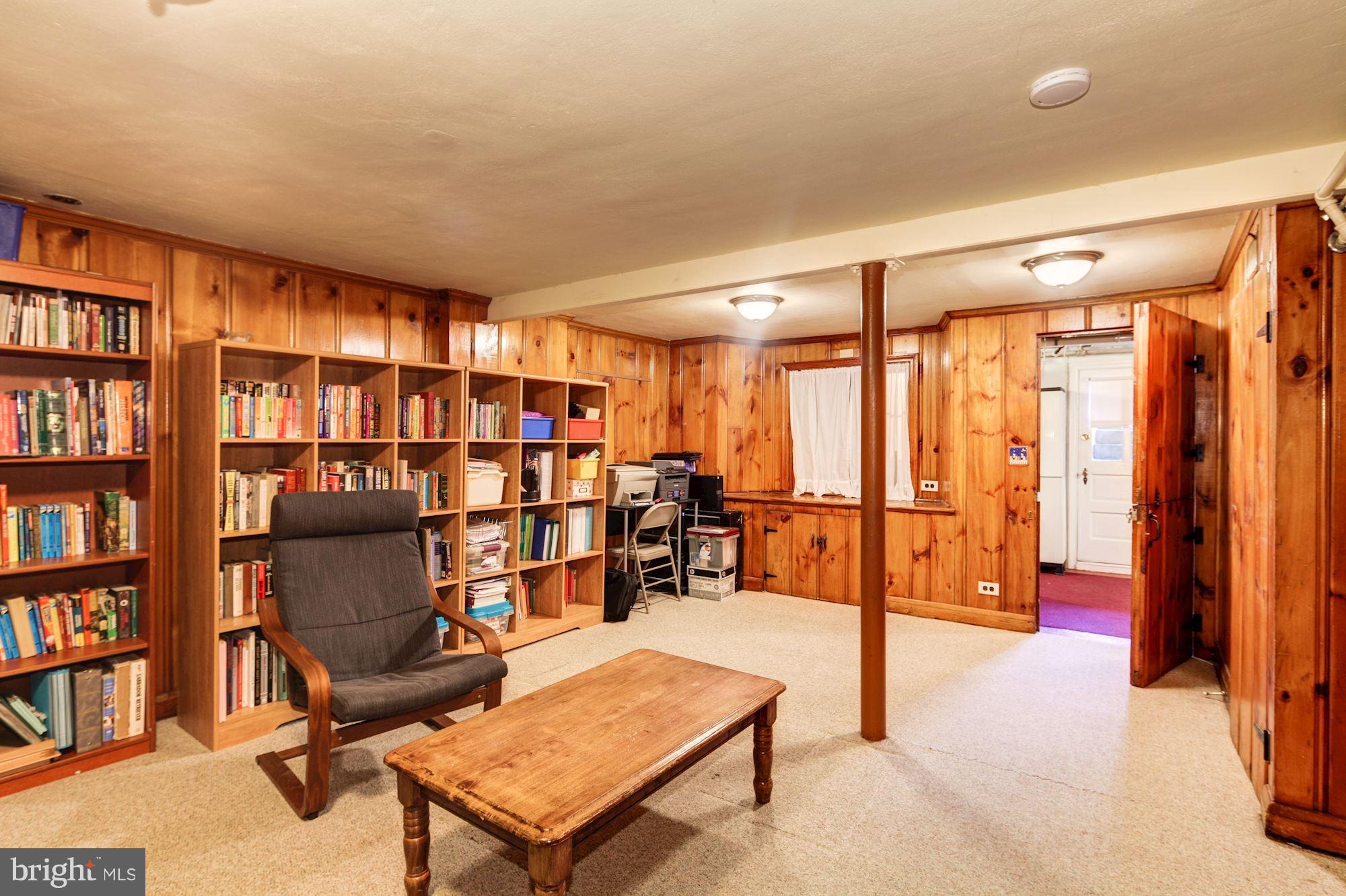 222 Ridge Avenue Baltimore, MD 21286 - Photo 23 of 30 a living room with lots of furniture and a book shelf