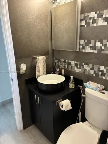 a bathroom with a sink a toilet and a mirror