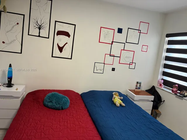 a bedroom with furniture and wooden floor