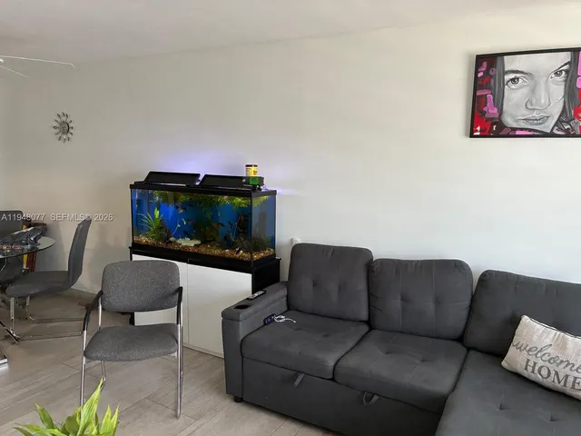a living room with furniture a couch and a flat screen tv