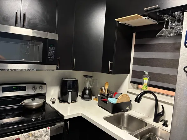 a kitchen with a appliances a stove and cabinets