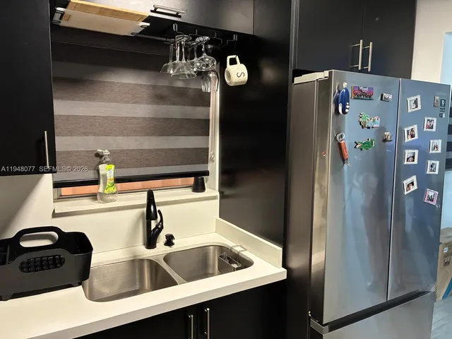 a kitchen with a refrigerator and a sink