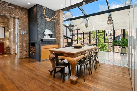 a kitchen with stainless steel appliances granite countertop a sink a stove and a wooden floors
