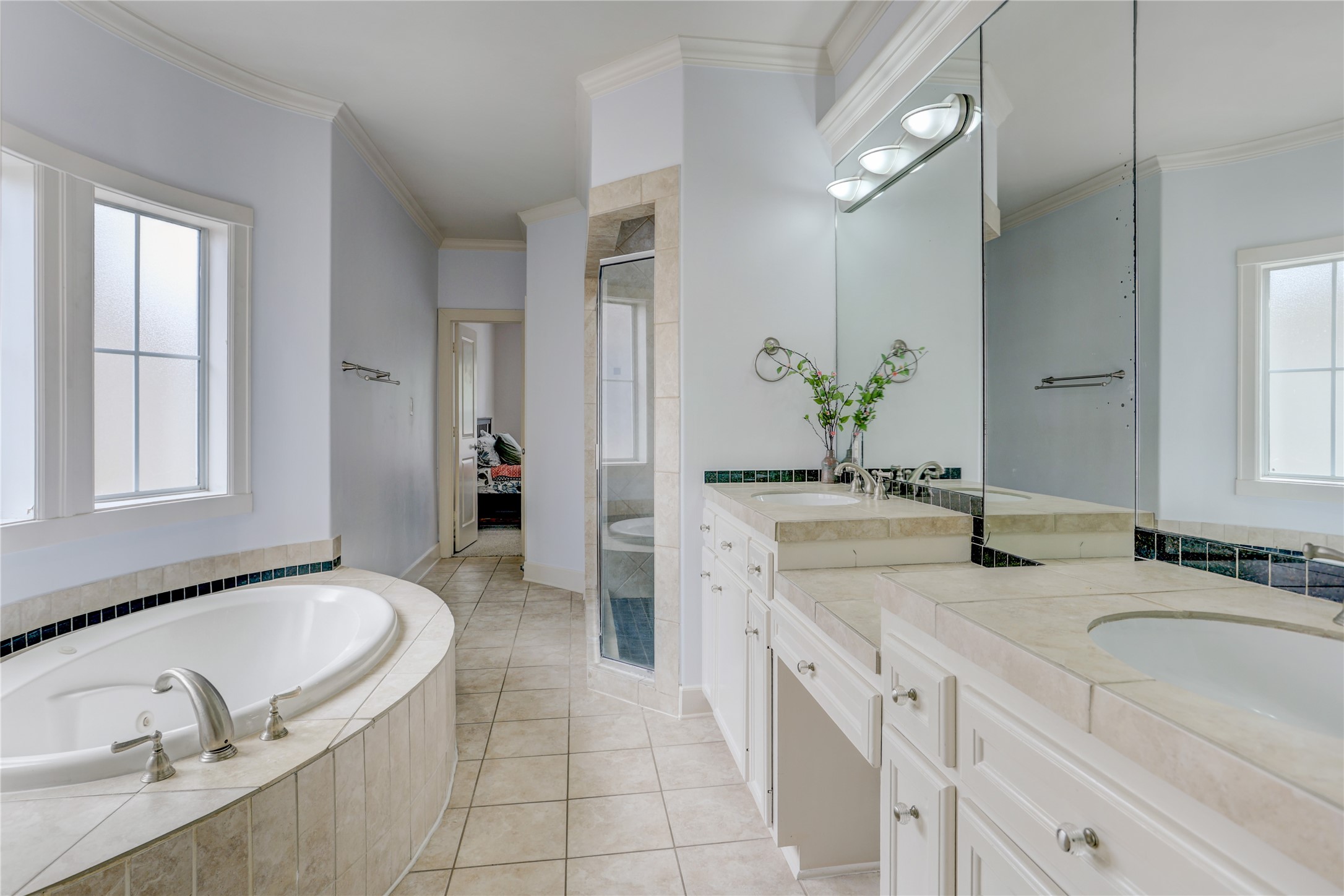 4262 Childress Street, Unit B Houston, TX 77005 - Photo 17 of 22 a spacious en suite bathroom with a granite countertop tub sink and mirror