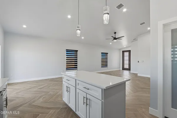 an entryway with kitchen and windows