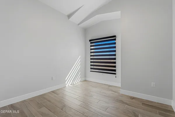 a view of a room with wooden floor