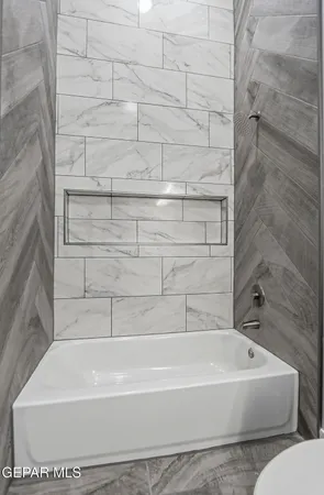 a bathroom with bathtub and shower