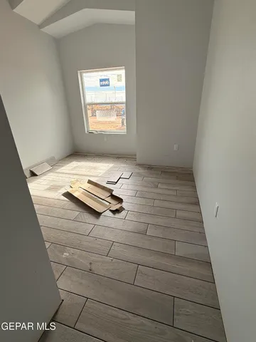 a view of a room with wooden floor