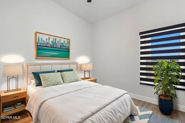 a bedroom with a bed and a potted plant