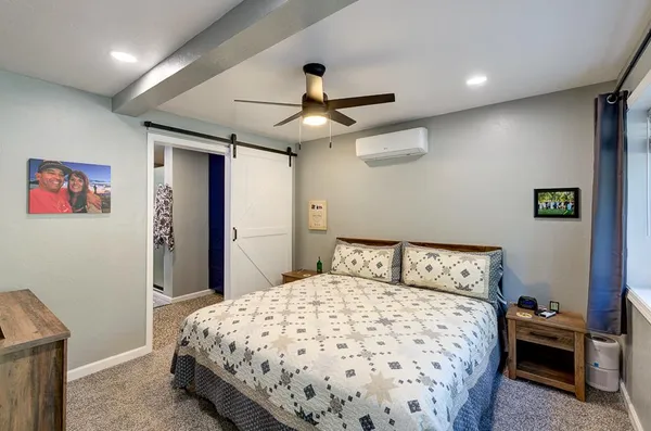 a bedroom with a large bed and a window
