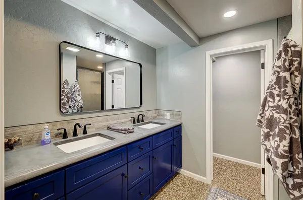 a bathroom with a sink toilet a mirror and shower