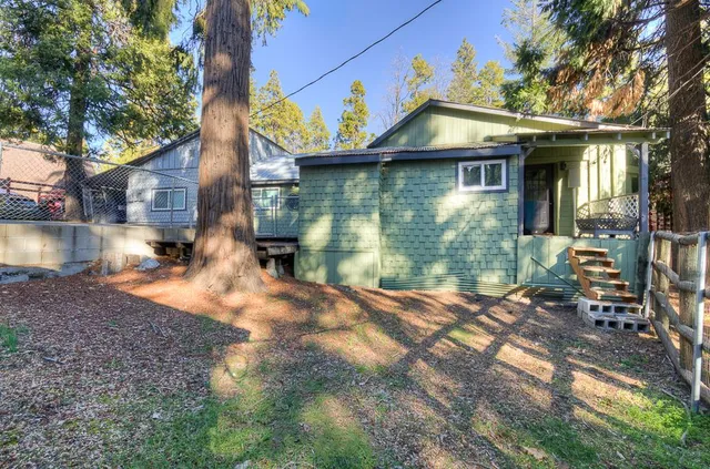 a kitchen with granite countertop a stove top oven a sink dishwasher a dining table and chairs with wooden floor