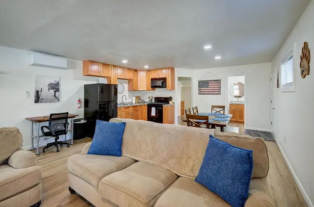 a view of backyard with a tub and wooden fence