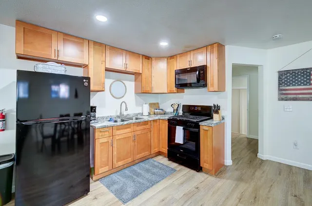 a living room with a couch and a table with wooden floor
