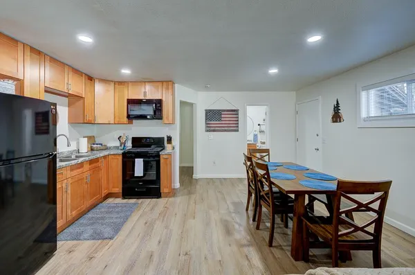 a kitchen with granite countertop a stove and a refrigerator