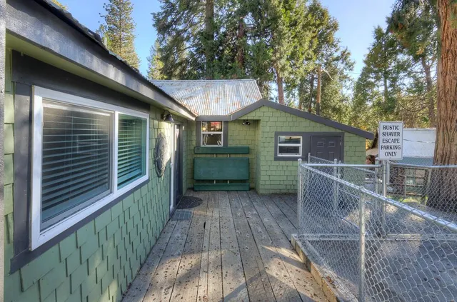 a view of a house with a yard and wooden fence