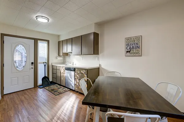 a kitchen with cabinets stainless steel appliances a sink and a refrigerator