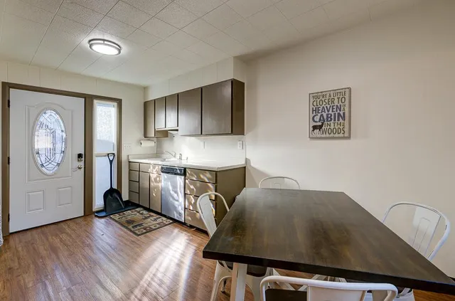 a kitchen with cabinets stainless steel appliances a sink and a refrigerator