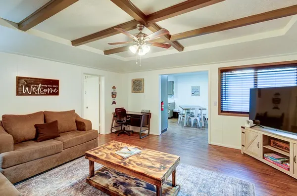 a view of a house with a yard and large tree