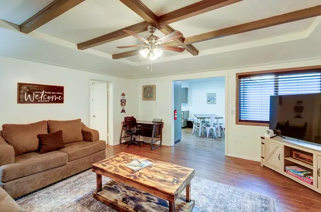 a view of a house with a yard and large tree