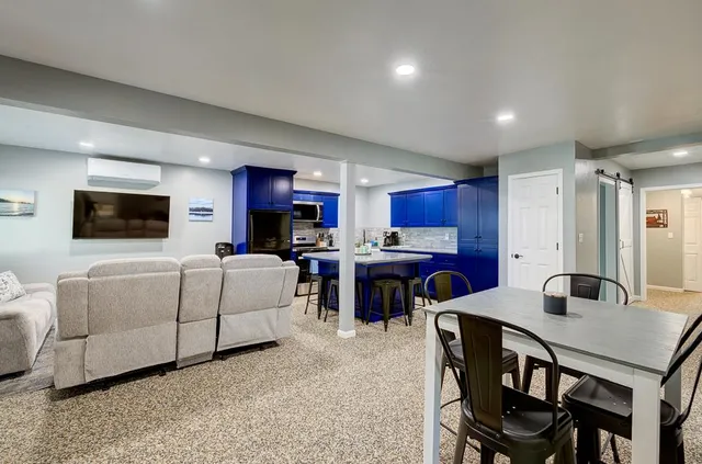 a kitchen with stainless steel appliances kitchen island granite countertop a refrigerator stove microwave and sink