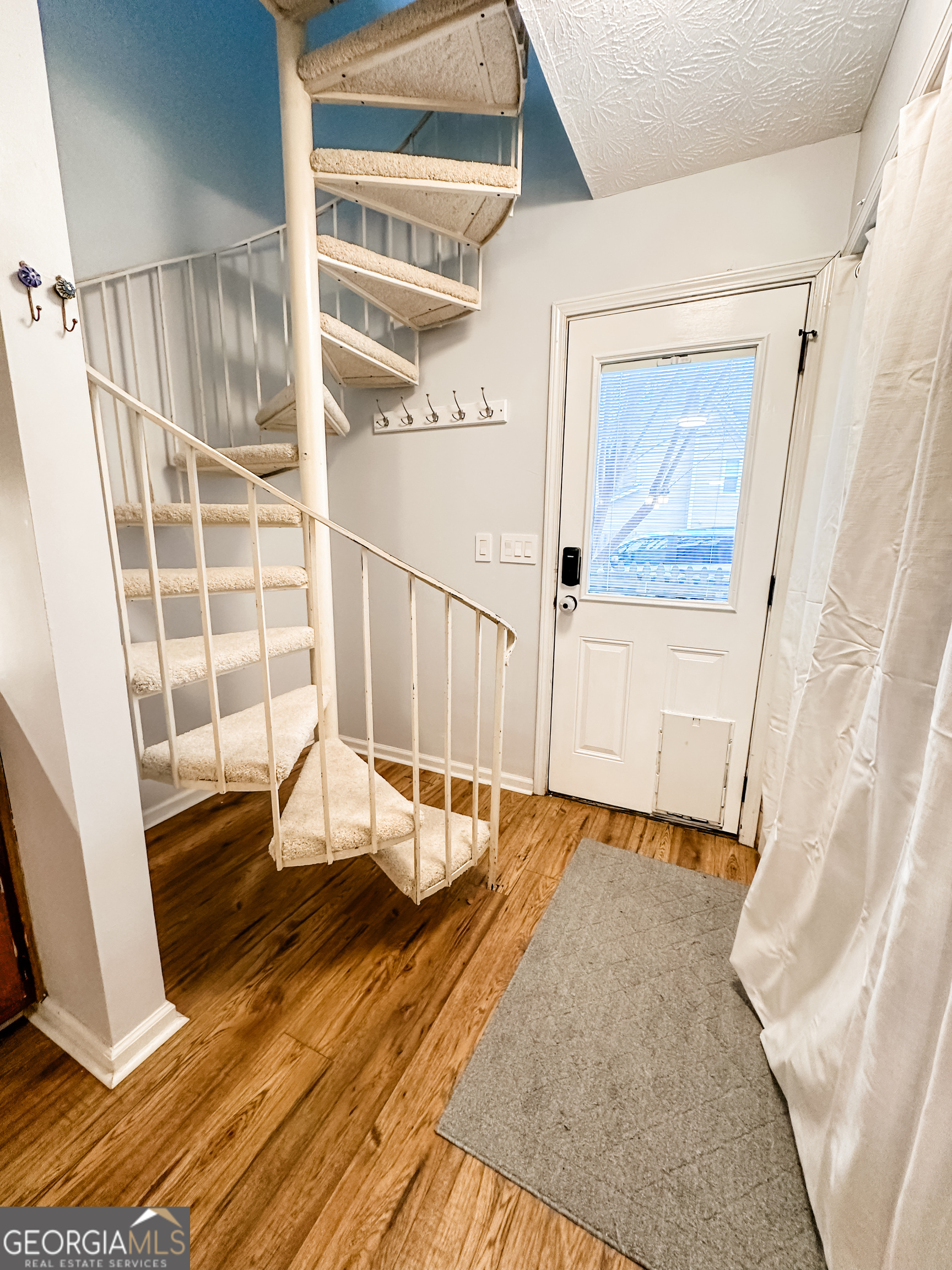 502 Richey Place Peachtree City, GA 30269 - Photo 13 of 61 a view of a balcony with wooden floor and white walls