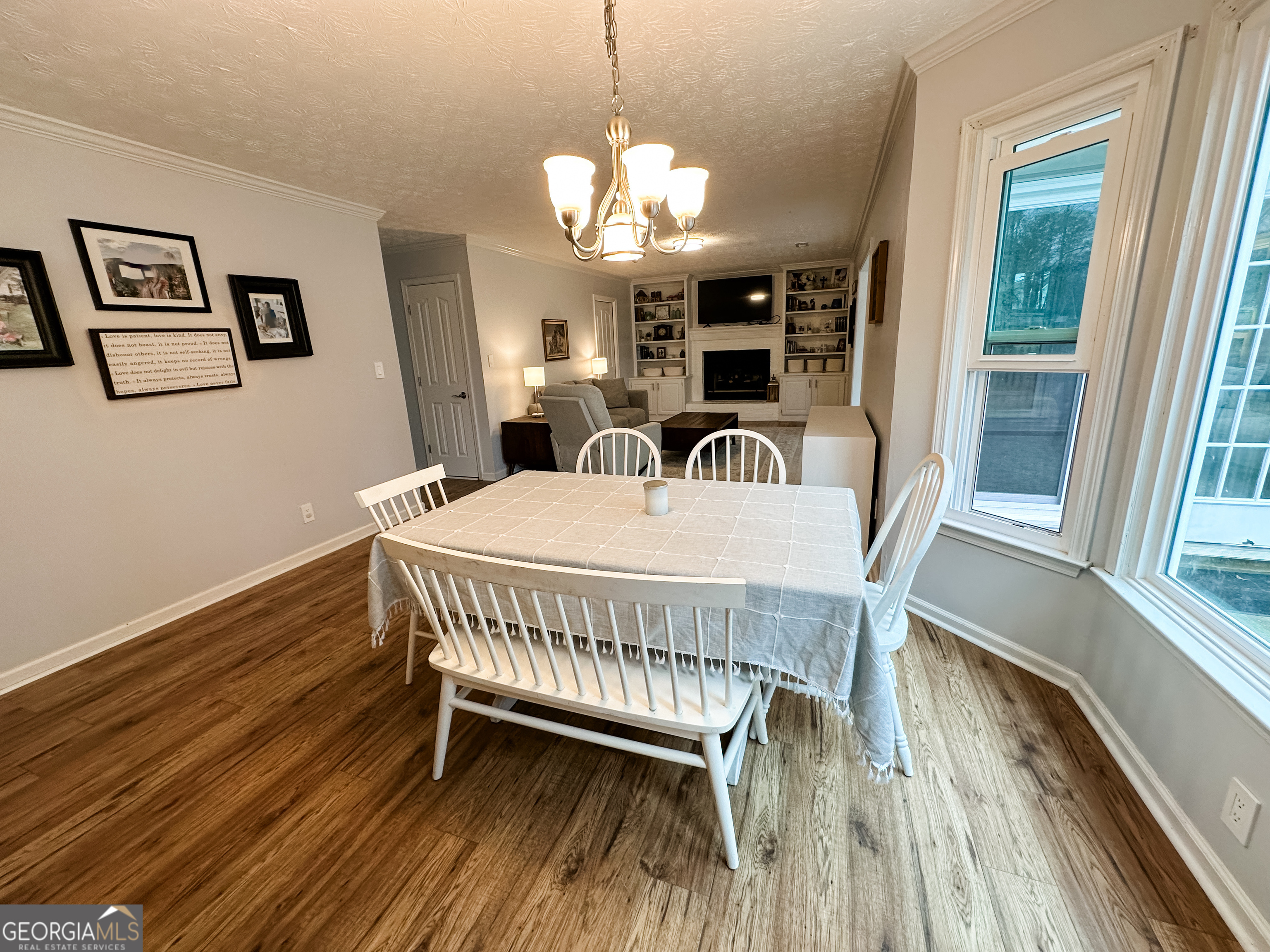 502 Richey Place Peachtree City, GA 30269 - Photo 16 of 61 a view of a dining room with furniture a chandelier and wooden floor