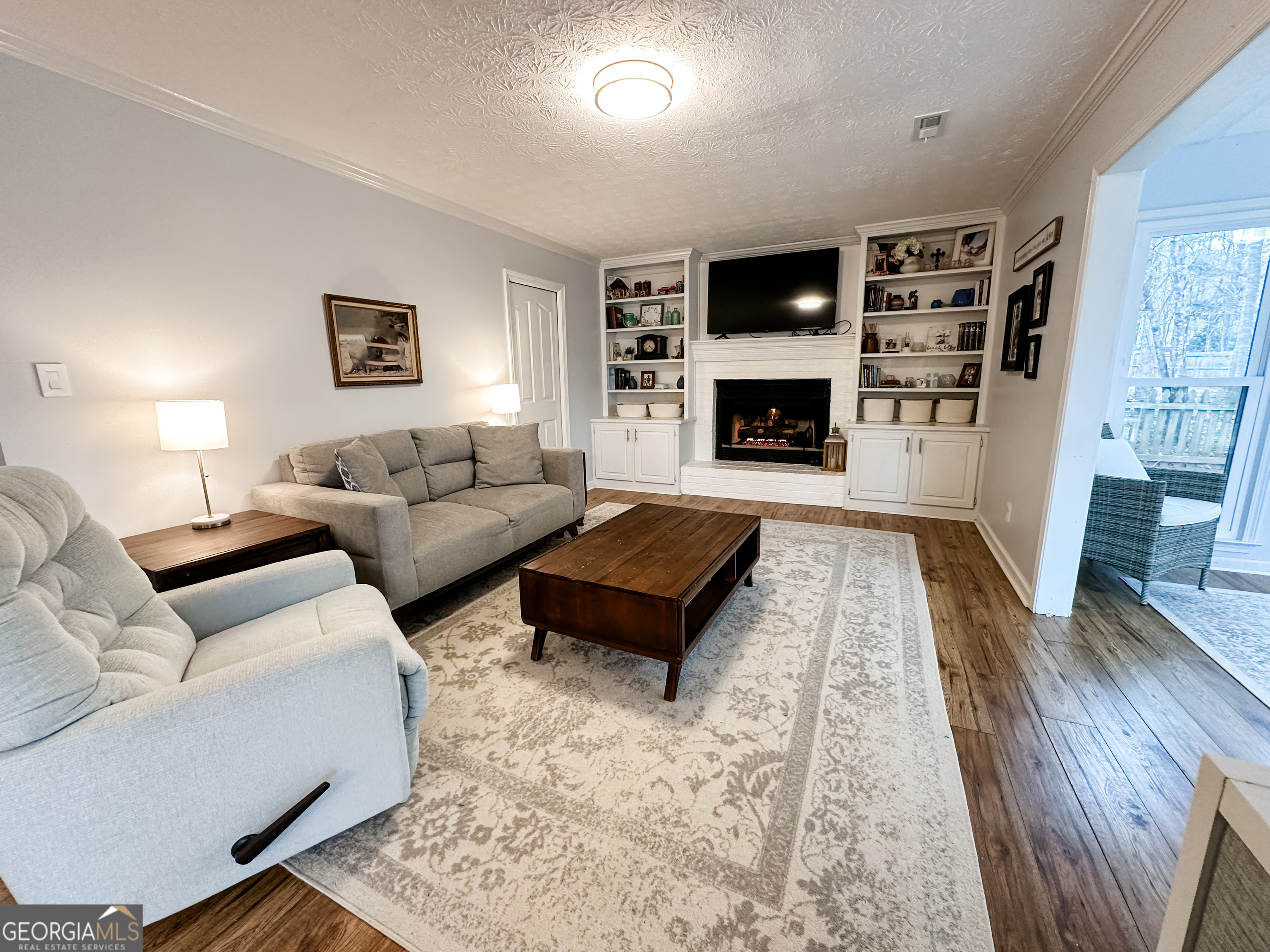 502 Richey Place Peachtree City, GA 30269 - Photo 21 of 61 a living room with furniture flat screen tv and a fireplace