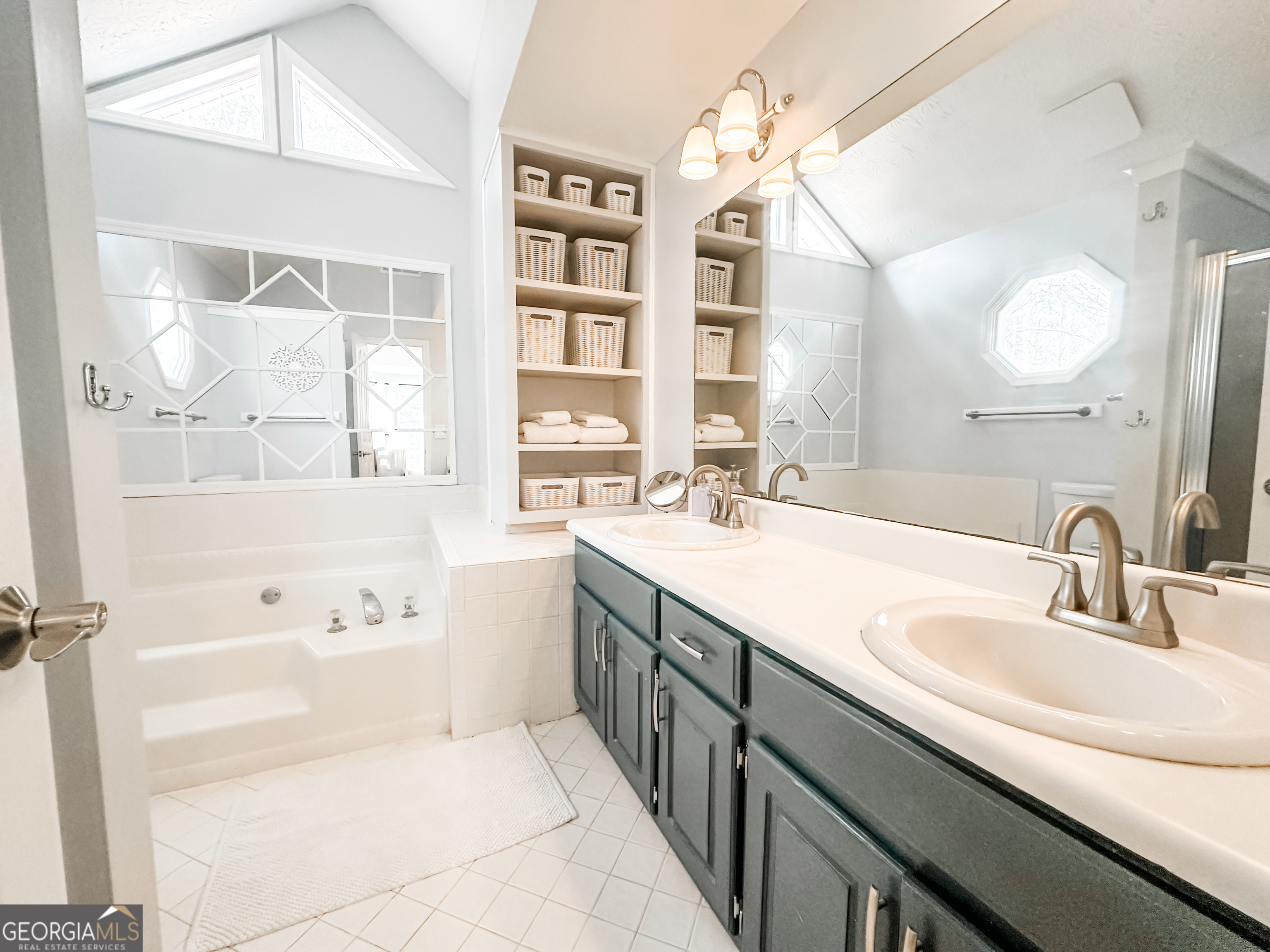 502 Richey Place Peachtree City, GA 30269 - Photo 33 of 61 a bathroom with a tub sink and mirror