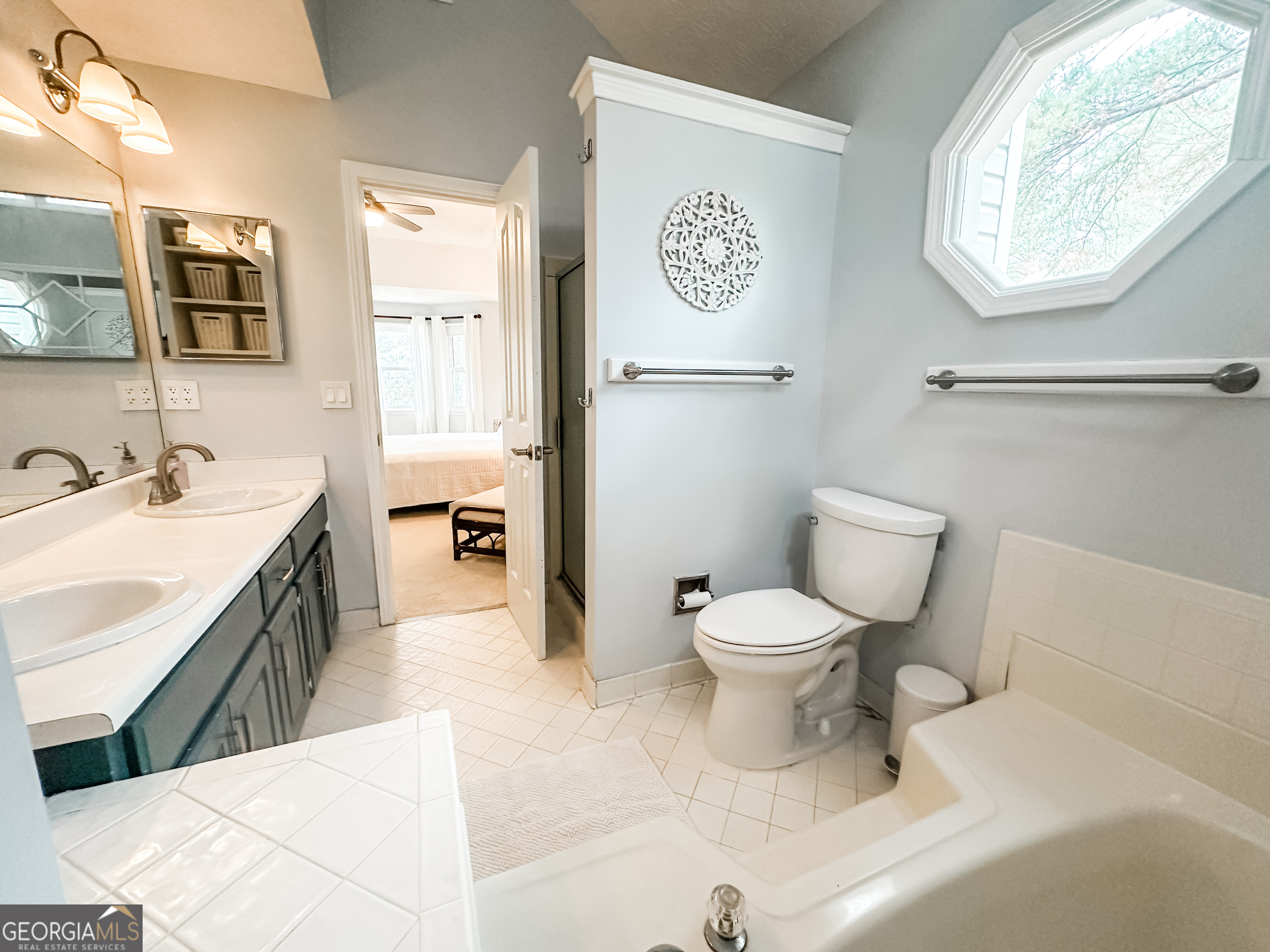 502 Richey Place Peachtree City, GA 30269 - Photo 34 of 61 a bathroom with a toilet sink and mirror