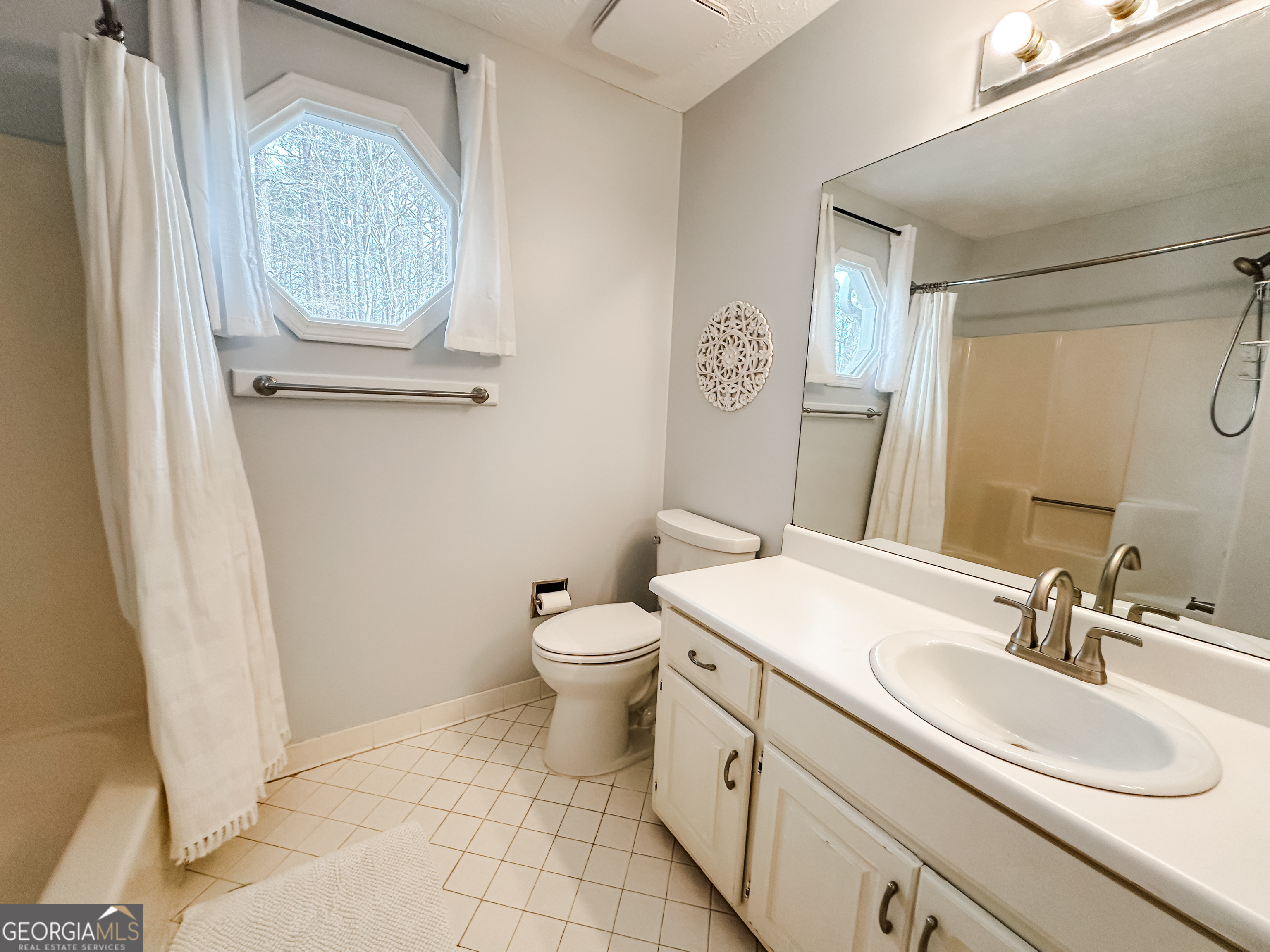 502 Richey Place Peachtree City, GA 30269 - Photo 49 of 61 a bathroom with a sink a toilet and a mirror