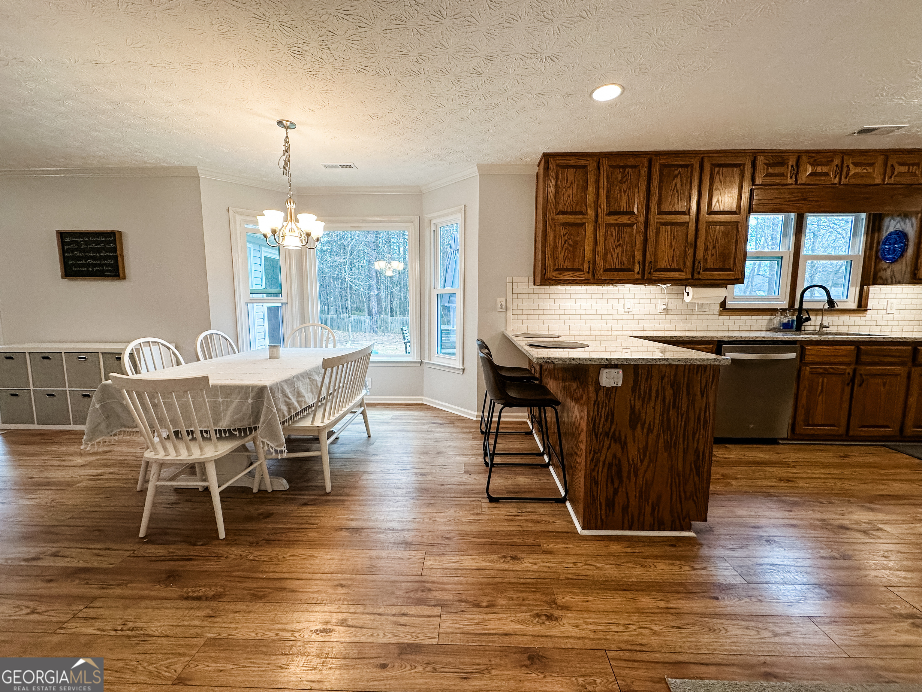 502 Richey Place Peachtree City, GA 30269 - Photo 5 of 61 a dining table with chairs and view of kitchen