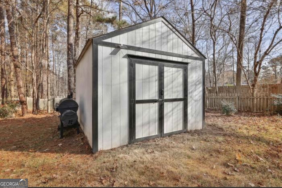 502 Richey Place Peachtree City, GA 30269 - Photo 59 of 61 a backyard of a house with wooden fence and large tree