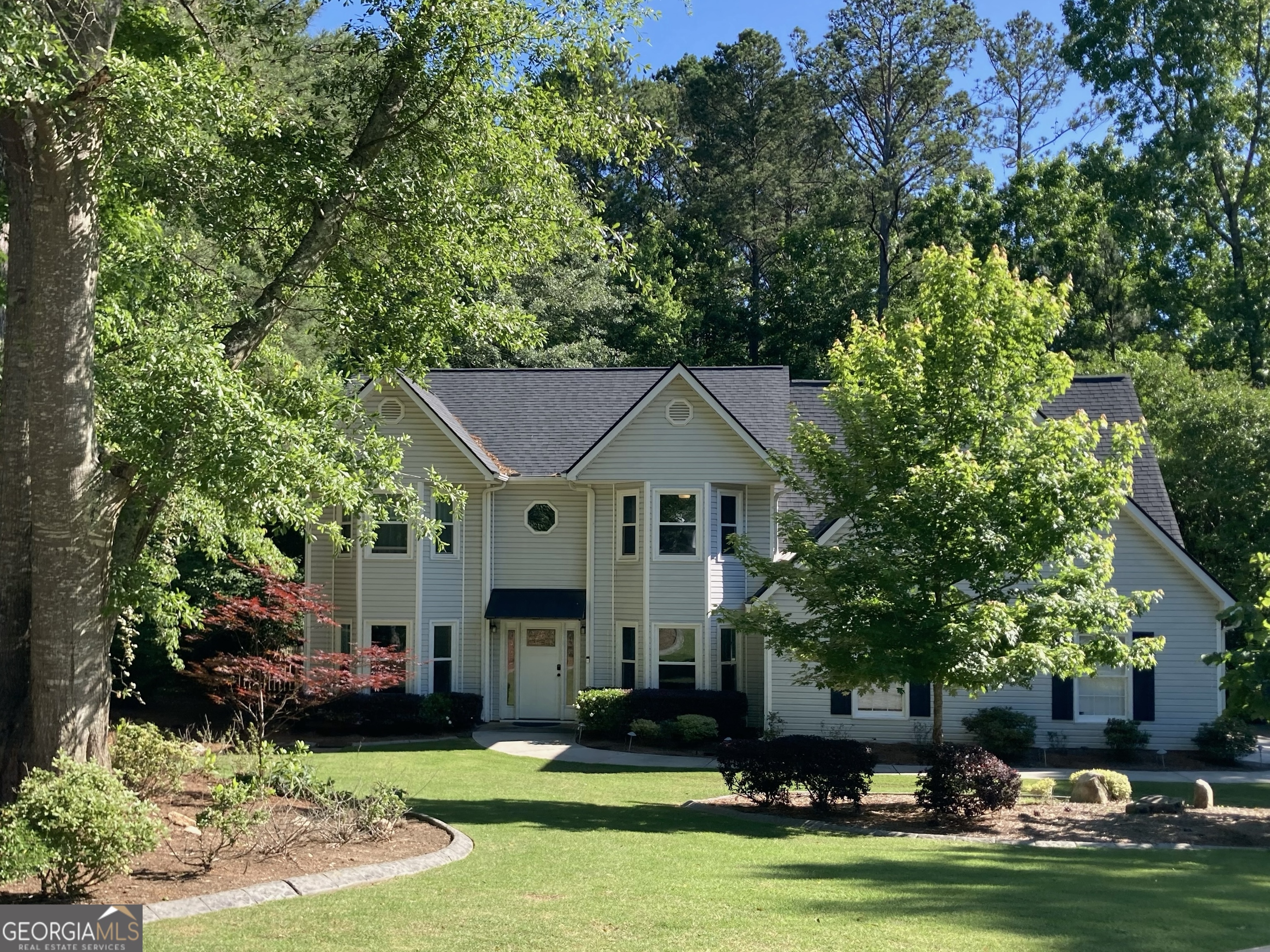 502 Richey Place Peachtree City, GA 30269 - Photo 60 of 61 a front view of a house with a garden and trees