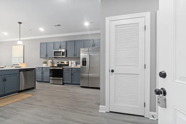 a kitchen with stainless steel appliances granite countertop a refrigerator and a sink