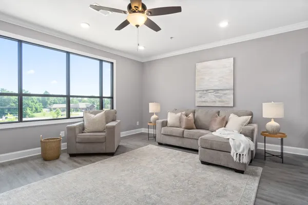 a living room with furniture and a large window