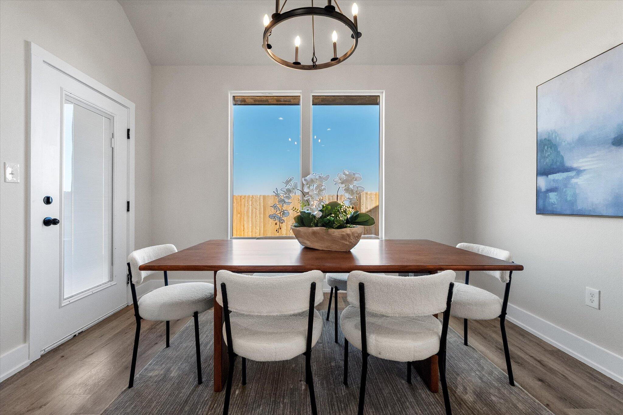 1404 Durham Avenue Wolfforth, TX 79382 - Photo 14 of 34 a dining room with furniture and wooden floor
