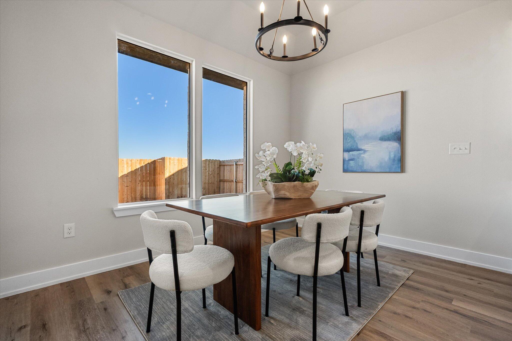 1404 Durham Avenue Wolfforth, TX 79382 - Photo 15 of 34 a view of a dining room with furniture and wooden floor