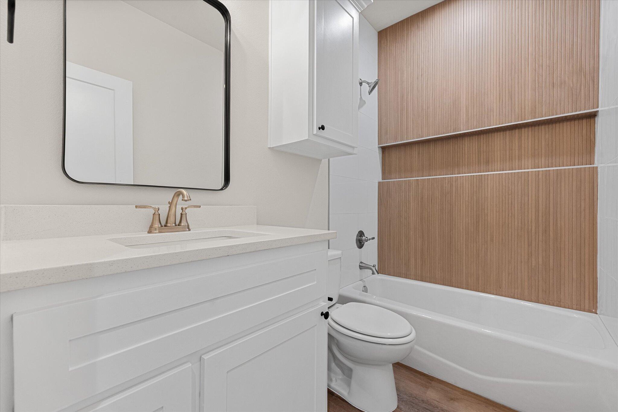 1404 Durham Avenue Wolfforth, TX 79382 - Photo 18 of 34 a bathroom with a sink a toilet and shower