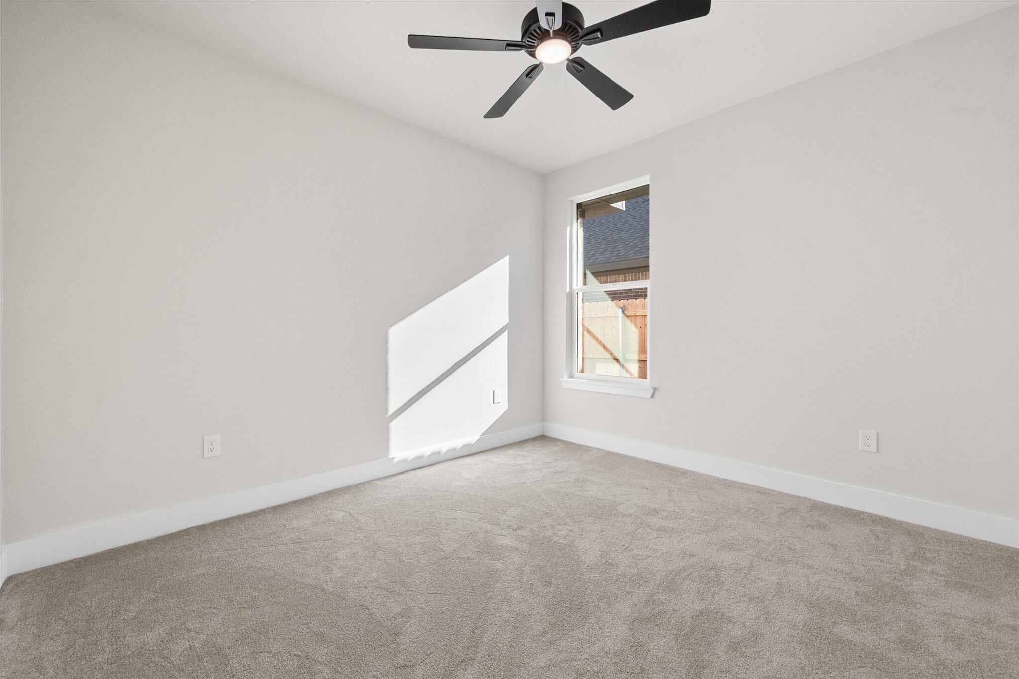 1404 Durham Avenue Wolfforth, TX 79382 - Photo 19 of 34 a view of an empty room with a window