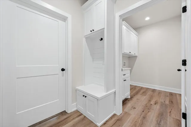 a view of storage and utility room with wooden floor