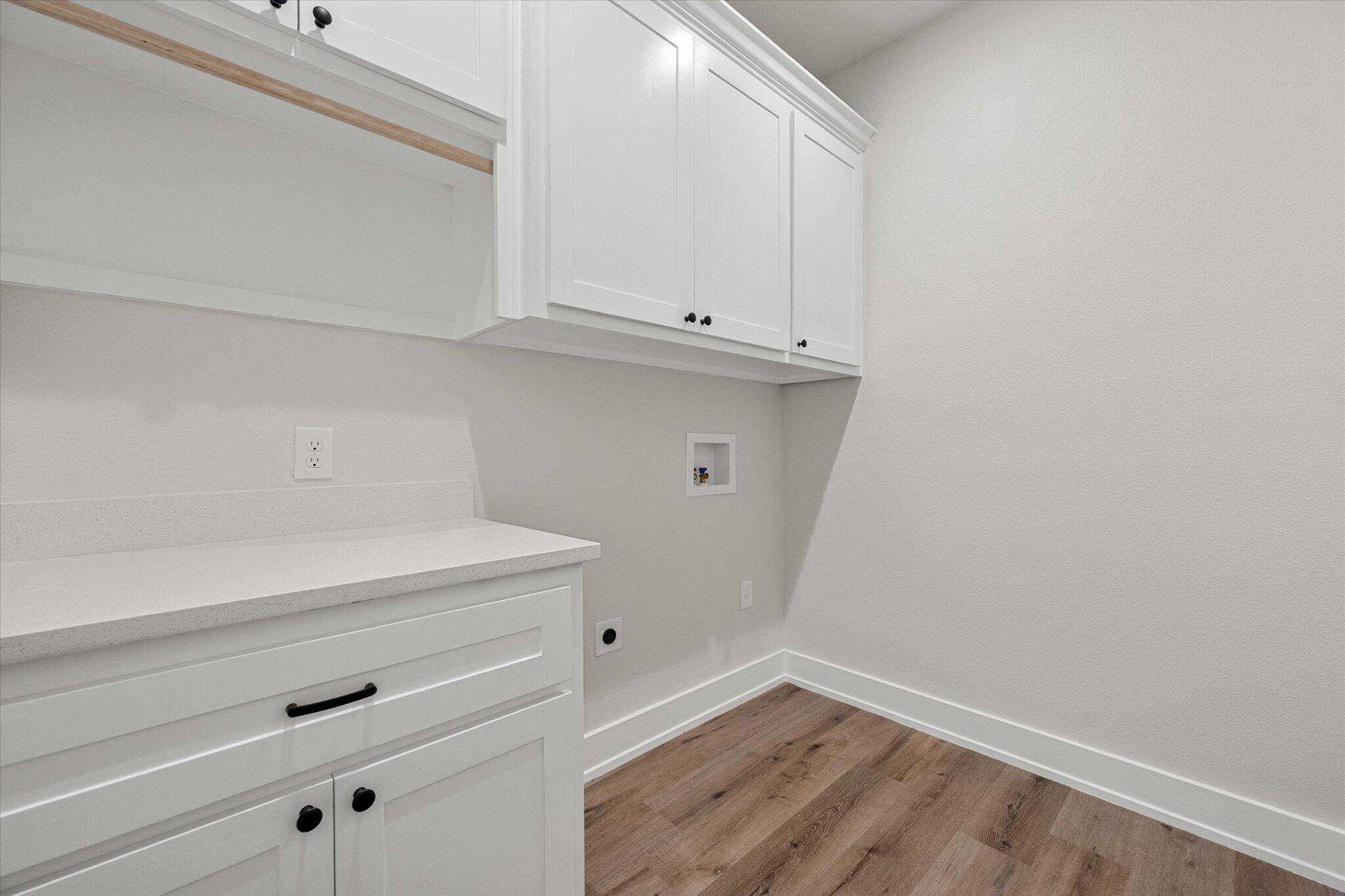 1404 Durham Avenue Wolfforth, TX 79382 - Photo 21 of 34 a view of storage and utility room with wooden floor