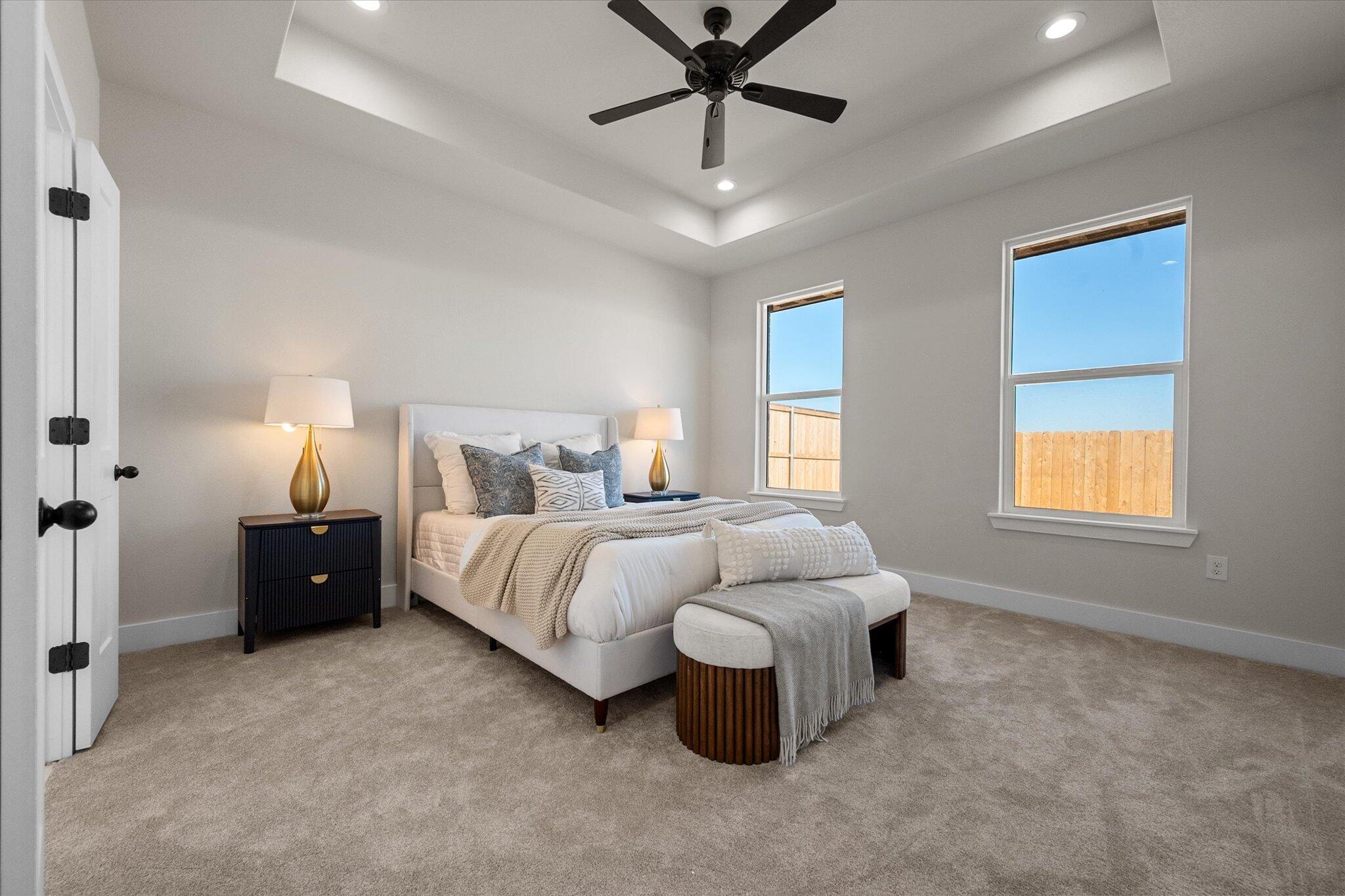 1404 Durham Avenue Wolfforth, TX 79382 - Photo 24 of 34 a spacious bedroom with a bed and a window