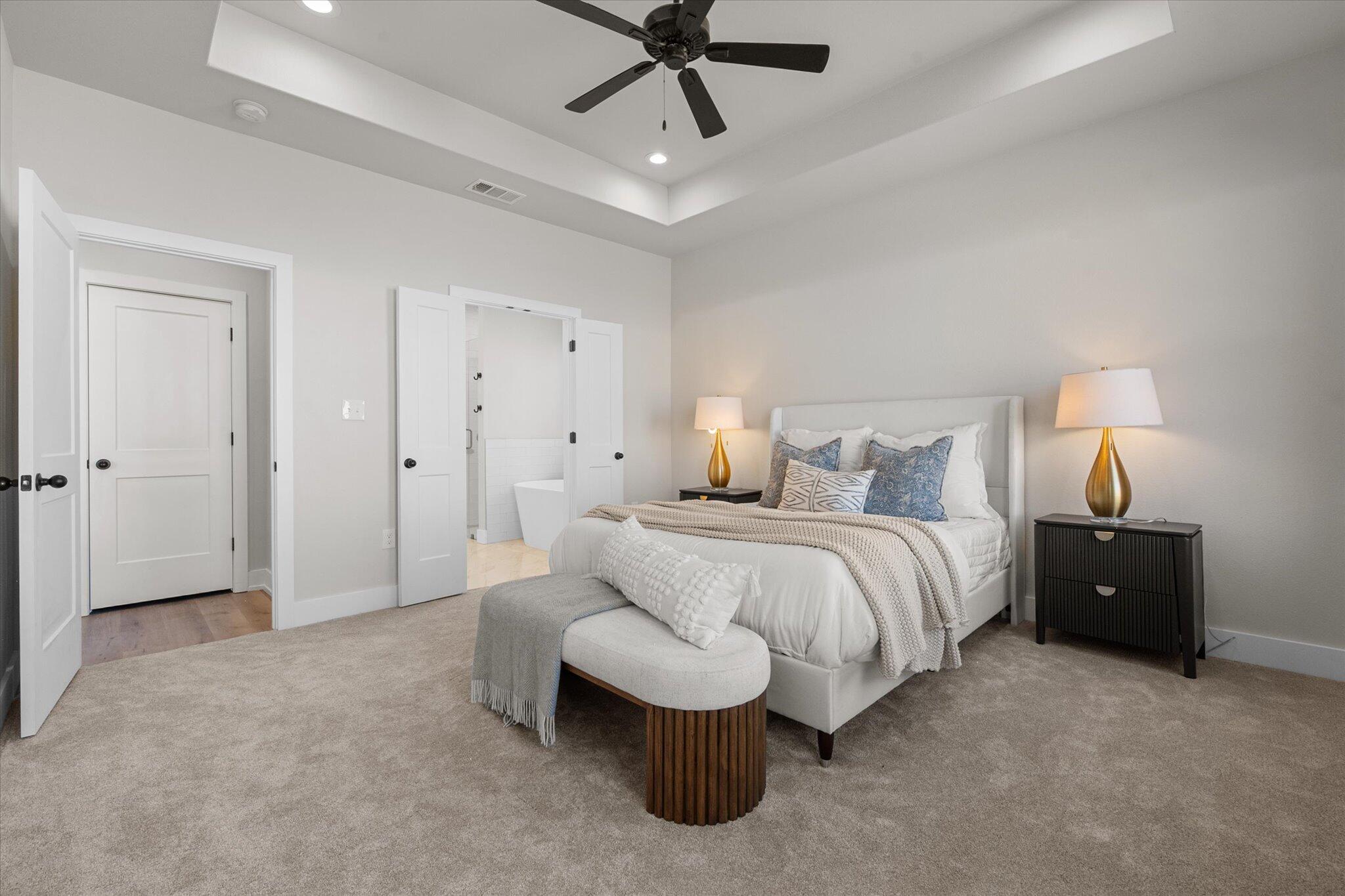 1404 Durham Avenue Wolfforth, TX 79382 - Photo 25 of 34 a spacious bedroom with a bed and ceiling fan