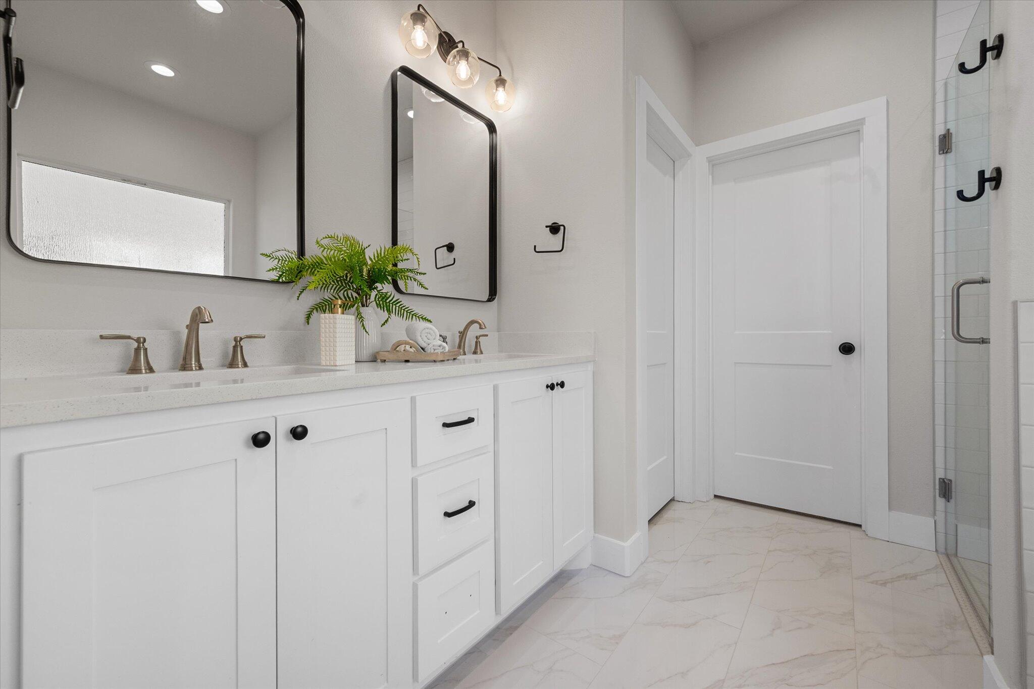 1404 Durham Avenue Wolfforth, TX 79382 - Photo 26 of 34 a bathroom with a double vanity sink and mirror