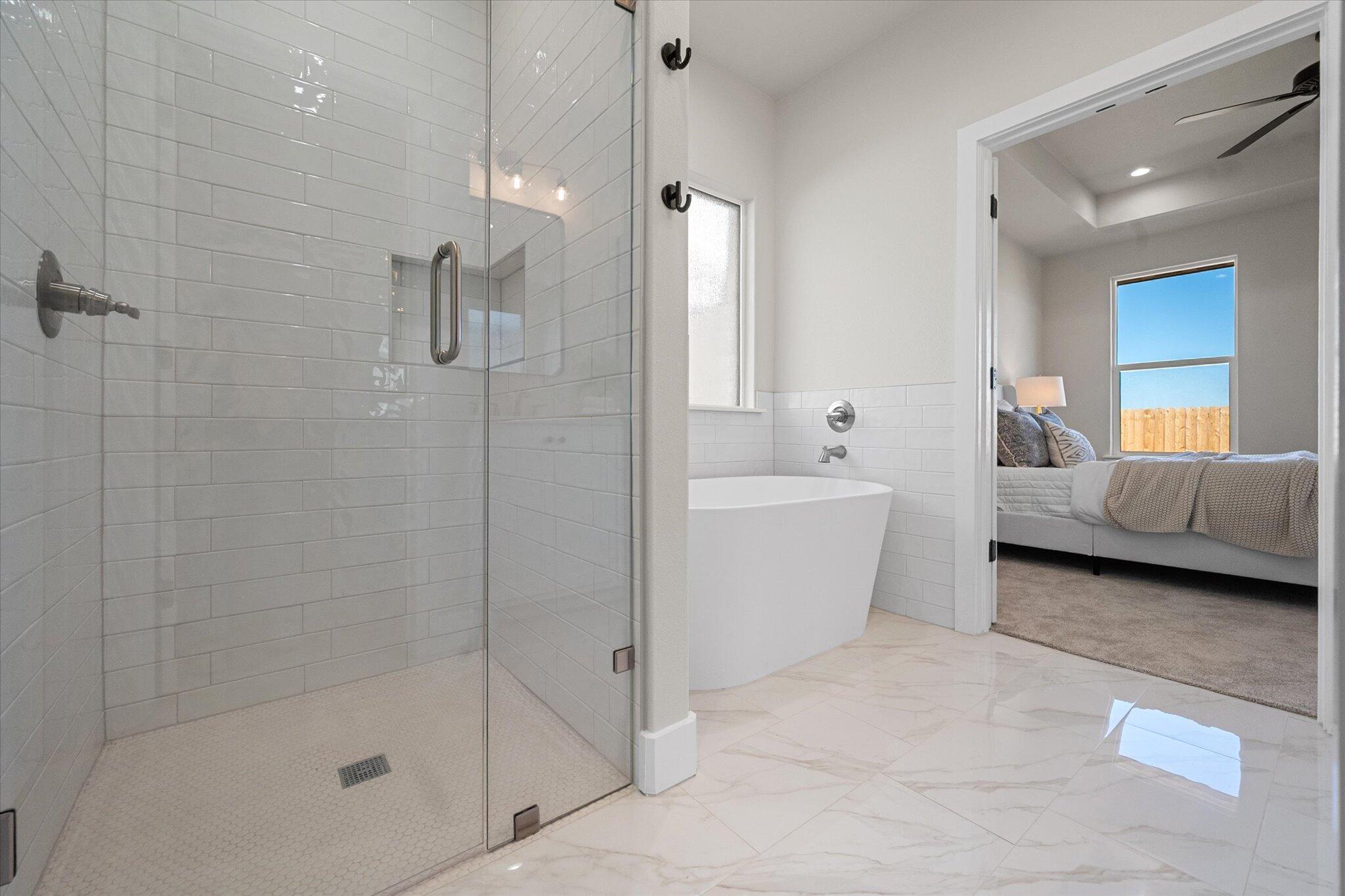 1404 Durham Avenue Wolfforth, TX 79382 - Photo 28 of 34 a bathroom with a bathtub and a shower