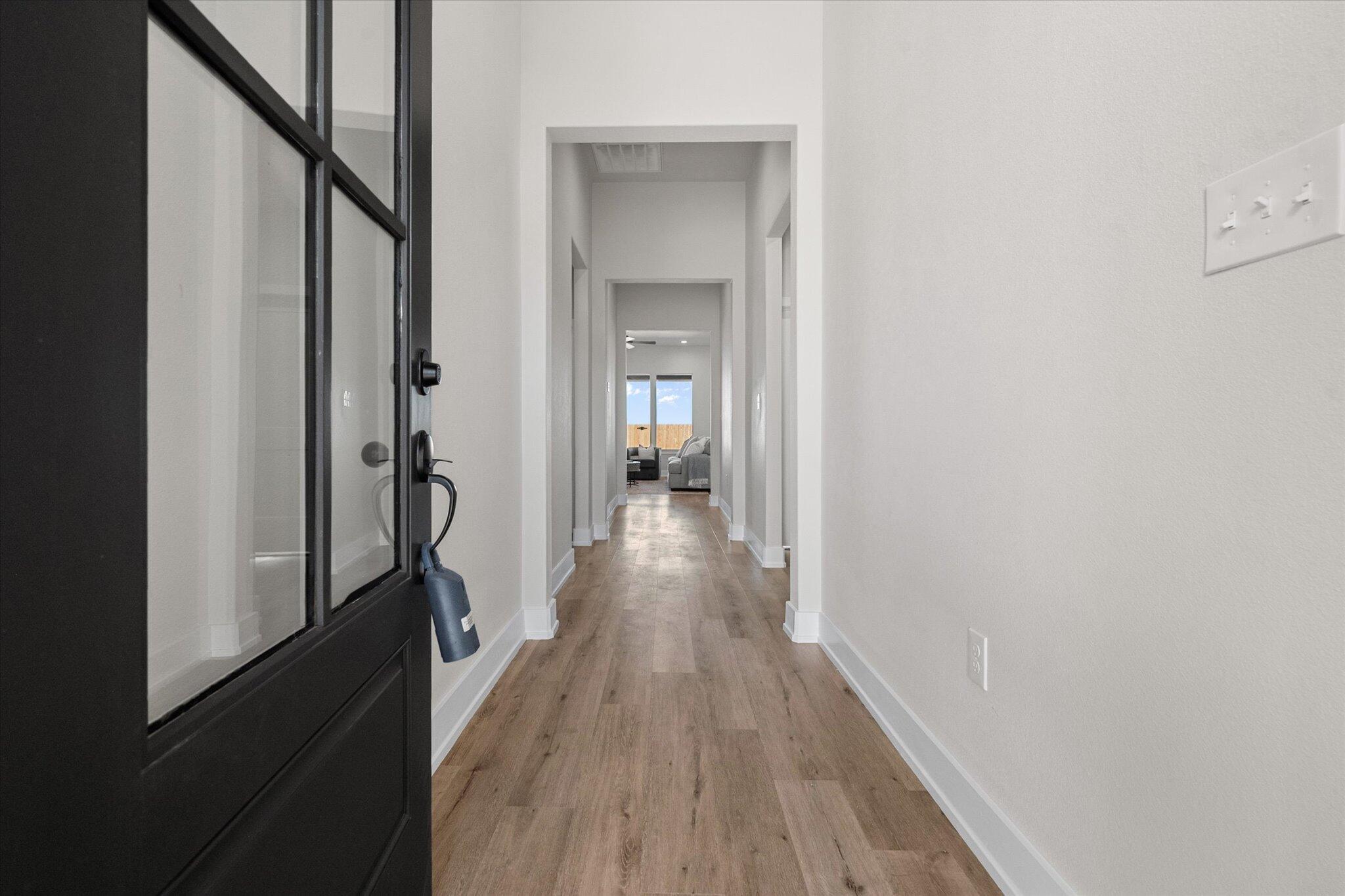 1404 Durham Avenue Wolfforth, TX 79382 - Photo 4 of 34 a view of a hallway with wooden floor and staircase