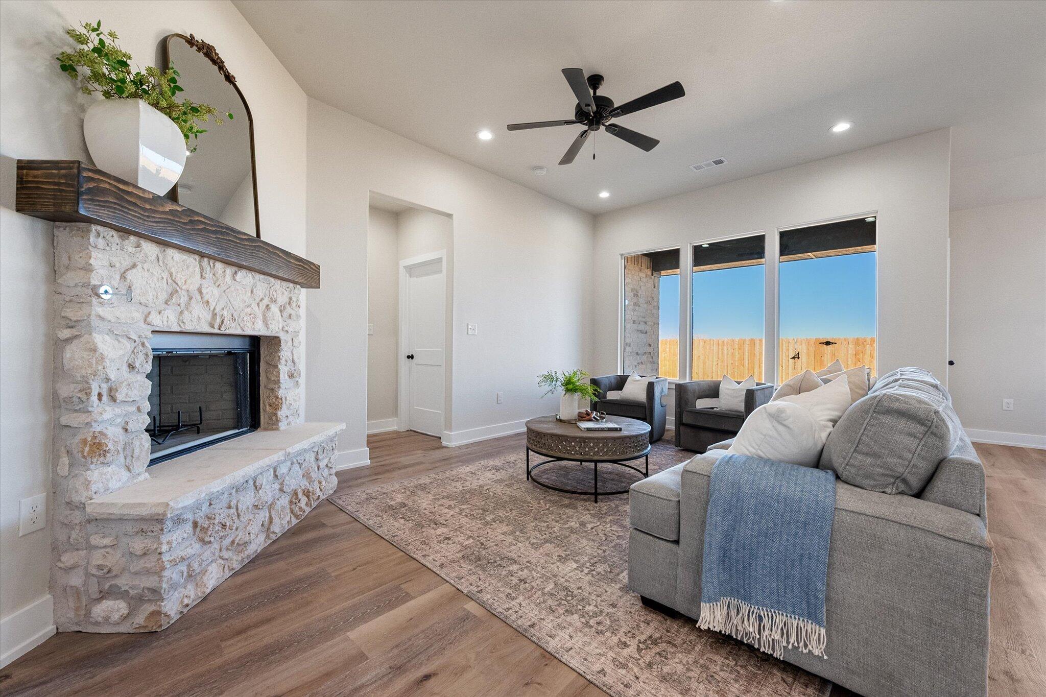 1404 Durham Avenue Wolfforth, TX 79382 - Photo 5 of 34 a living room with furniture and a fireplace