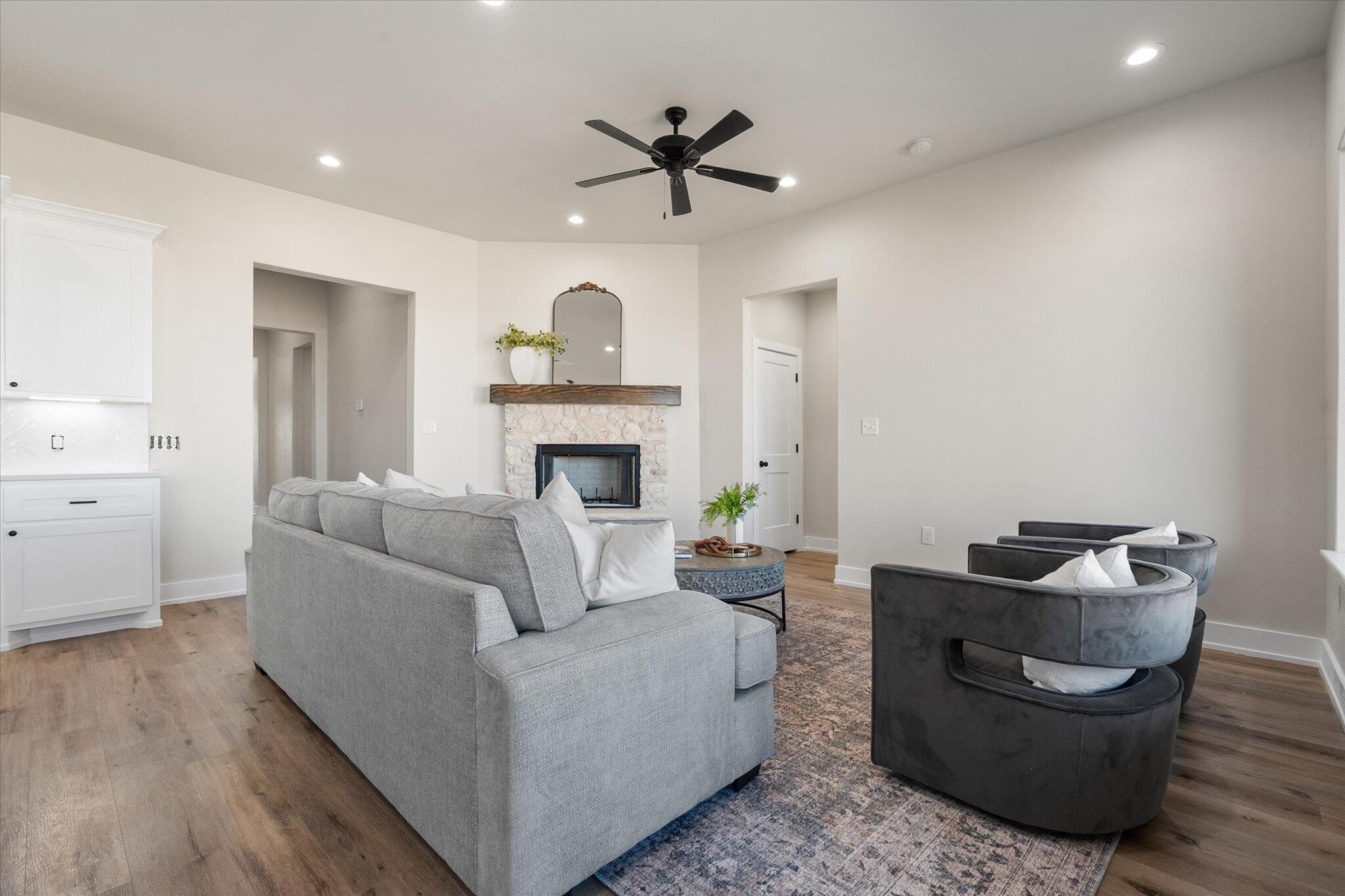 1404 Durham Avenue Wolfforth, TX 79382 - Photo 8 of 34 a living room with furniture and a fireplace
