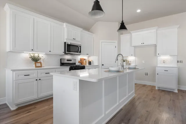 a kitchen with cabinets a sink and appliances